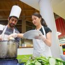 two students cooking in the Segundo Dining Commons for a cooking competition