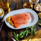 fish, olive oil, and garlic laid out on a brown table